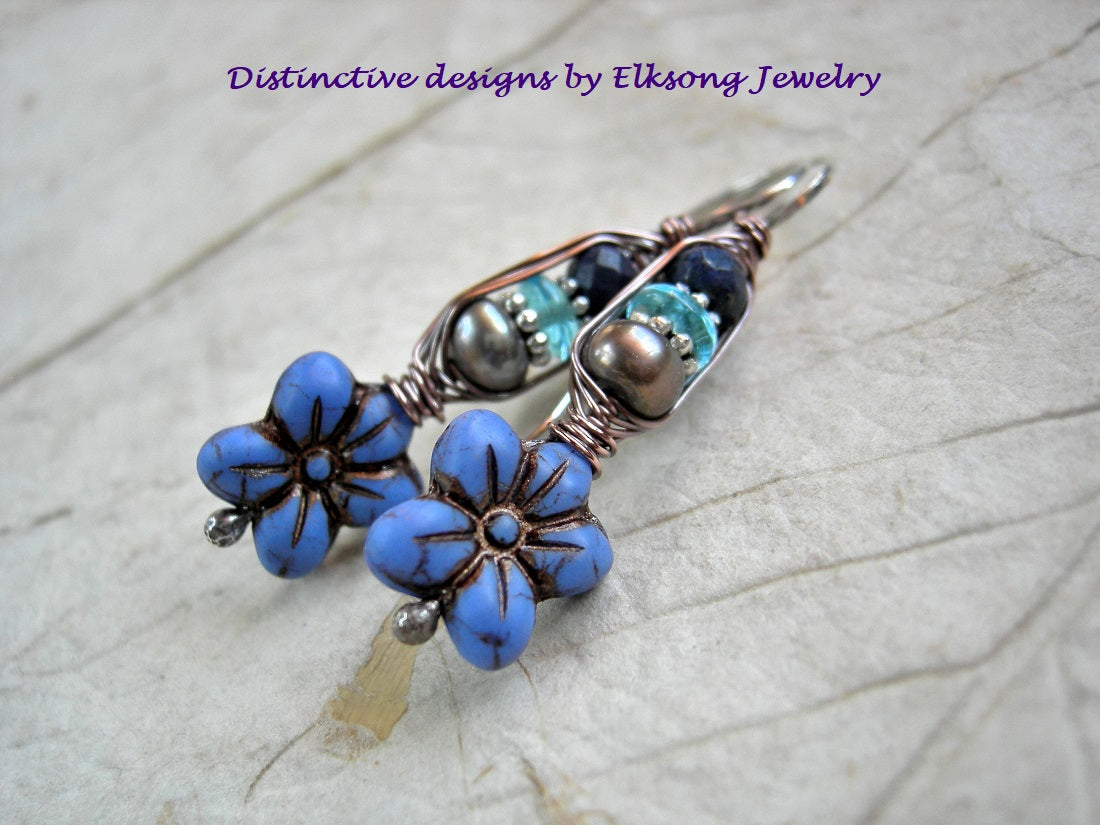 Cornflower earrings in shades of blue, with glass flowers, freshwater pearls & faceted lapis. Wrapped ear hook style. 