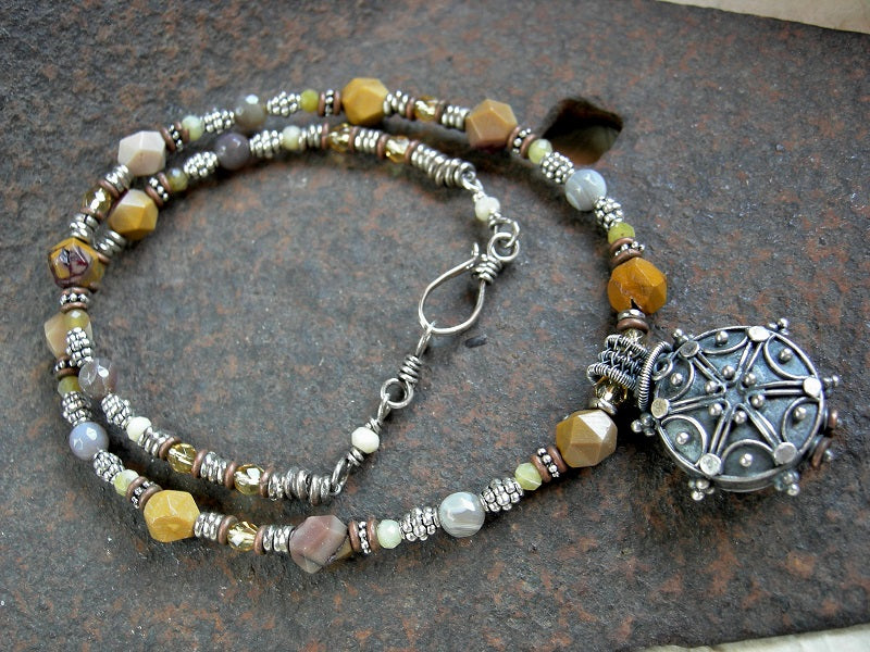 Faceted yellow gemstone bead necklace with silver Bali focal, silver & copper heishi & hook and eye clasp. 