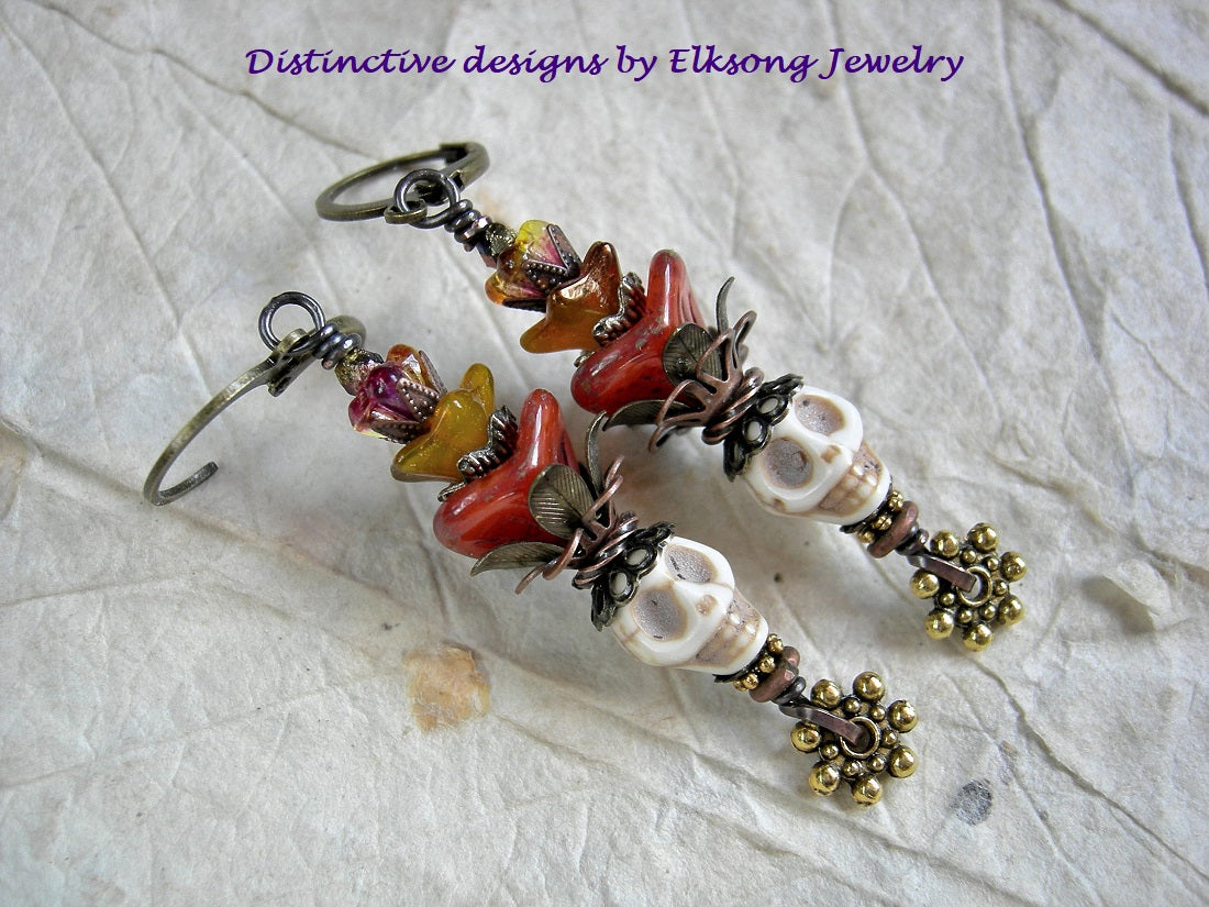 Sun Queen earrings with bone magnesite sugar skulls, orange & yellow glass flowers, brass & copper filigree. 