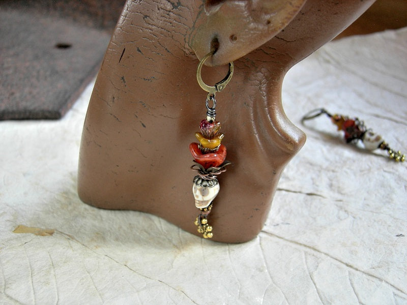 Dia de los Muertos style earrings with bone magnesite sugar skulls, orange & yellow glass flowers, brass & copper filigree. 