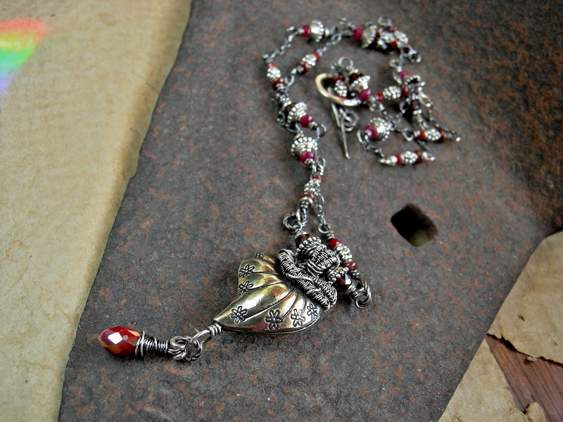 Thai style silver heart pendant with sterling wire wrap & faceted garnet and crystal beads. 