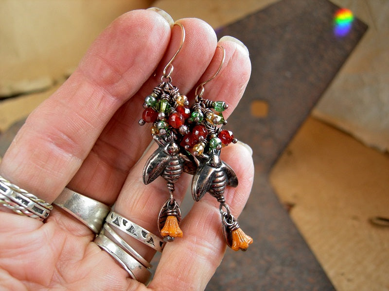 Copper bee cluster style earrings with  faceted orange red carnelian, glass flowers & copper leaf charms. 