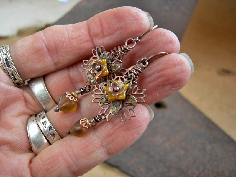 Boho filigree style earrings with antiqued copper & brass petals, yellow glass flowers & heart shaped beads. 