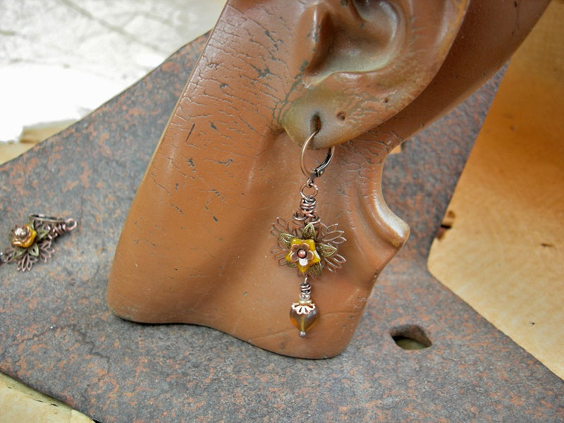 Sunflower earrings with antiqued copper & brass filigree petals, yellow glass flowers & heart shaped beads. 