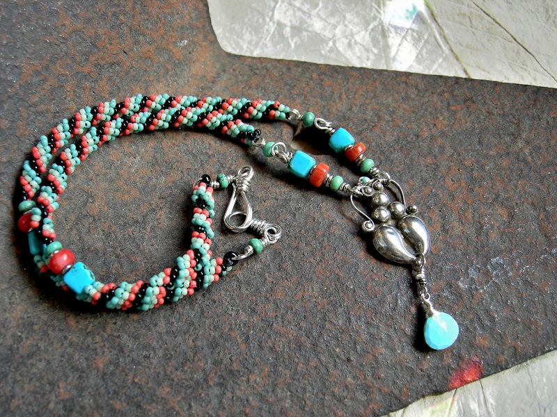 Boho luxe woven bead necklace in turquoise & coral colors. Gemstone beads, sterling goddess focal, faceted turquoise briolette. 