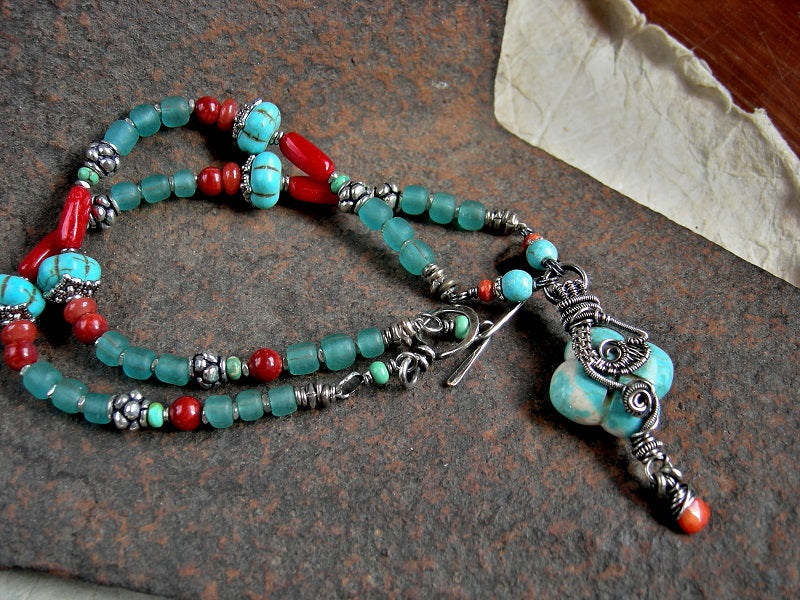 Boho luxe strung bead necklace with vivid red bamboo coral, genuine turquoise & colored magnesite, silver Bali style beads, Java glass & sterling wire wrapped focal. 