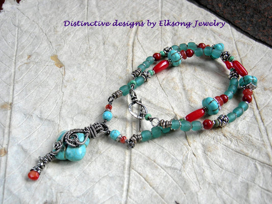 East Meets West necklace with vivid red bamboo coral, genuine turquoise & colored magnesite, silver Bali style beads, Java glass & sterling wire wrapped focal. 