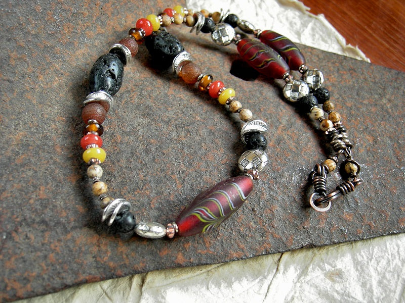 Strung bead necklace with vintage Czech glass "feather" beads, lava stone, picture jasper, carnelian. Black, amber, russet colors. 